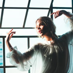 A person's hands in a graceful mudra position.