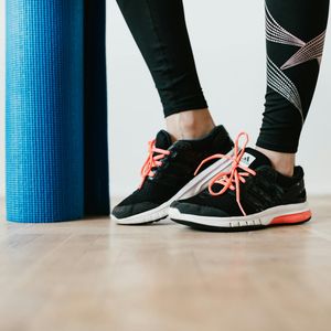 Close-up of a yoga mat on a wooden floor, ready for practice.