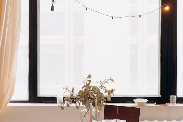 Woman performing a calm yoga stretch in a minimalist, bright room.